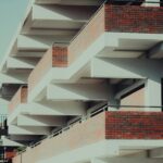 Modern apartment building with geometric design and brick facade.